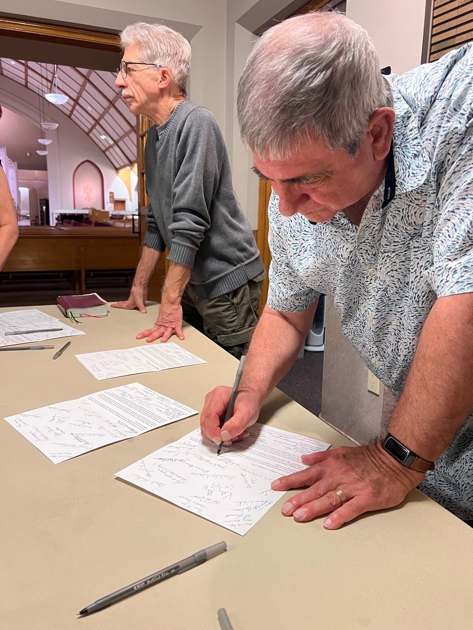 Guests sign greeting cards for local faith communities.